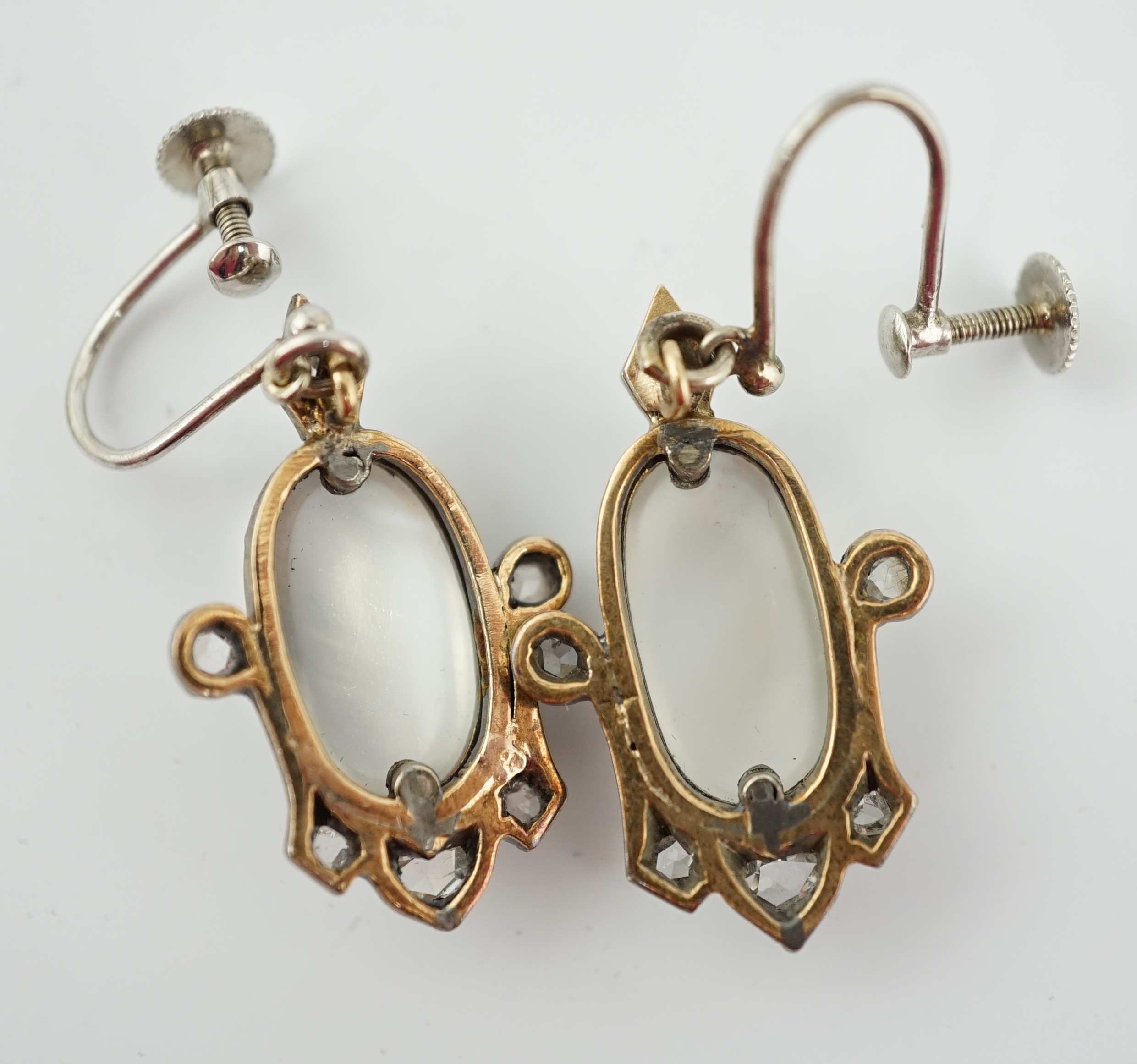 A pair of early 19th century gold and silver, cabochon moonstone and rose cut diamond cluster set drop ear clips